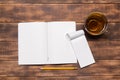 top view image of open notebook with blank pages next to cup of coffee on wooden table. ready for adding text Royalty Free Stock Photo