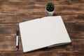 Top view image of open notebook with blank pages next to cup of coffee on wooden table. ready for adding text Royalty Free Stock Photo