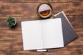 Top view image of open notebook with blank pages next to cup of coffee on wooden table. ready for adding text Royalty Free Stock Photo