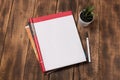 top view image of open notebook with blank pages next to cup of coffee on wooden table. ready for adding mockup Royalty Free Stock Photo