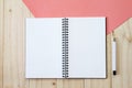 Top view image of open notebook with blank pages and pen on wooden background, ready for adding or mock up Royalty Free Stock Photo