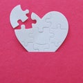 Top view image of paper white heart puzzle with missing piece over pink background. Health care, donate, world heart day and world Royalty Free Stock Photo