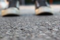 Top view image of person with shoes over asphalt road Royalty Free Stock Photo