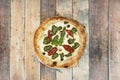 top view image of pizza with dried tomatoes, black olives, pesto sauce Royalty Free Stock Photo