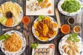 Top view image of a plate of food cooked in a Chinese restaurant with udon noodles, orange duck, Pekin duck, salmon makis,