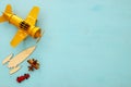 Top view image of retro yellow metal toy airplane over blue background. Royalty Free Stock Photo