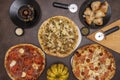 Top view image of seafood pizza with smoked salmon and prawns, pumpkin, pizza with prosciutto, garlic bread, mushroom Royalty Free Stock Photo