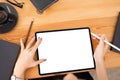 Top view image shot of businesswoman hands using tablet with  screen on woden desk at office workplace Royalty Free Stock Photo