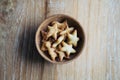 Top view image of small biscuits in many shapes in wooden cup Royalty Free Stock Photo