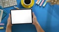 Top view image of smart man`s hands holding a cropped black computer tablet with white blank screen . Royalty Free Stock Photo