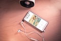 Top view image of smartphone,earphones and speaker with Cosmo Sheldrake`s song on screen