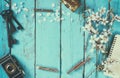 Top view image of spring white cherry blossoms tree, blank notebook, old camera on blue wooden table. vintage filtered and toned Royalty Free Stock Photo