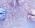 Top view image of three different pair of slippers of Asian women standing in a circle at the sandy beac