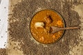 Top view image traditional lentil stew from northern Spain with wooden spoon, bacon, chorizo and some vegetables scattered on a