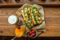 Top view image of two baguette sandwiches, red cherries, and two glasses of juices on a wooden table Royalty Free Stock Photo