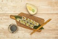 Top view image of uramaki california roll sushi with sesame seeds, nori seaweed, cream cheese, salmon and ripe avocado Royalty Free Stock Photo