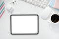 The top view image of white workspace is surrounding by a white blank screen tablet and various equipment Royalty Free Stock Photo