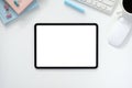 The top view image of white workspace is surrounding by a white blank screen tablet and various equipment Royalty Free Stock Photo