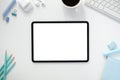 The top view image of white workspace is surrounding by a white blank screen tablet and various equipment Royalty Free Stock Photo