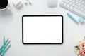 The top view image of white workspace is surrounding by a white blank screen tablet and various equipment Royalty Free Stock Photo