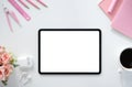 The top view image of white workspace is surrounding by a white blank screen tablet and various equipment Royalty Free Stock Photo