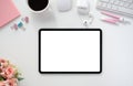 The top view image of white workspace is surrounding by a white blank screen tablet and various equipment Royalty Free Stock Photo