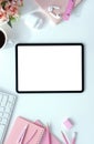 The top view image of white workspace is surrounding by a white blank screen tablet Royalty Free Stock Photo