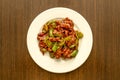 Top view image of wok-fried beef strips with green peppers on a white plate cooked Royalty Free Stock Photo