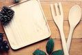 Top view image of wooden spoon, fork and blank tray placed on wooden table on vintage background, Different wooden kitchen tools Royalty Free Stock Photo