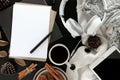 Top view image of workspace. tablet computer, coffee, paper and scarf on black table