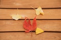 Top view image of Yellow ginkgo biloba leaves and red maple leaves at wooden bench chair Royalty Free Stock Photo