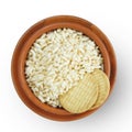 Top view of Indiana Puffed Rice and two biscuits on a brown clay pot, isolated on a white background Royalty Free Stock Photo