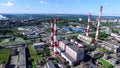 Top view of industrial area of city and plant with red and white pipes. Panorama of city with factories and plants