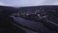 Top view of industrial city by river on summer evening. Clip. Beautiful landscape of industrial town by river among Royalty Free Stock Photo