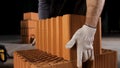 Top view of an industrial worker taking ceramic block at the construction site. Stock footage. Building new wall of