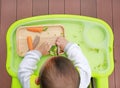 Top view of infant baby eating by Baby Led Weaning BLW. Finger foods concept Royalty Free Stock Photo