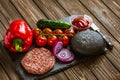 Top view of ingredients for beef black burger on a black stone board with knife. Delicious food Royalty Free Stock Photo