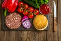 Top down view of ingredients for classic beef burger on black stone board with knife. Delicious food Royalty Free Stock Photo