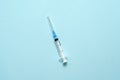 Top view of injection syringe on blue background. Minimal vaccine concept. Medical treatment of diabetes with insulin Royalty Free Stock Photo