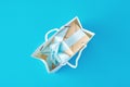 Top view inside open red paper shopping bag wirh gift box on blue background Royalty Free Stock Photo