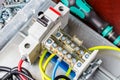 Top view of installed on DIN rail automatic circuit breaker and wire terminal against screwdriver and plastic box with screws and Royalty Free Stock Photo