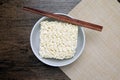 Top view of instant noodle in the glass bowl near the chopsticks Royalty Free Stock Photo