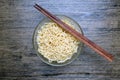 Top view of instant noodle in the glass bowl near the chopsticks Royalty Free Stock Photo