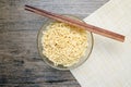 Top view of instant noodle in the glass bowl near the chopsticks Royalty Free Stock Photo