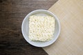 Top view of instant noodle in the glass bowl on the wooden table Royalty Free Stock Photo