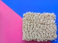 Top view of instant noodles with colored background