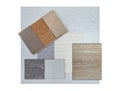top view of interior material samples board contains ash vinyl flooring tile, stone ceramic tiles, interior fabric wallpapers. Royalty Free Stock Photo
