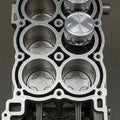 Engine block featuring four cylindrical bores each with visible Royalty Free Stock Photo