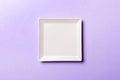 Top view of isolated of colored background empty square white plate for food. Empty dish with space for your design Royalty Free Stock Photo