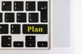 Top view isolated laptop keyboard with yellow `plan` text on button, concept design f Royalty Free Stock Photo